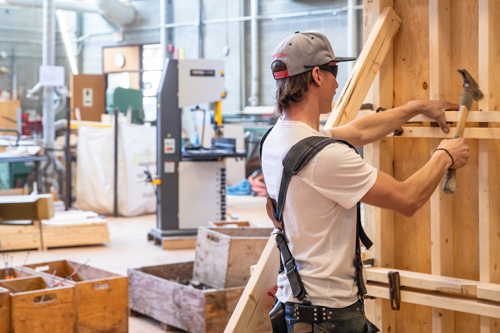 Carpentry student nailing wood