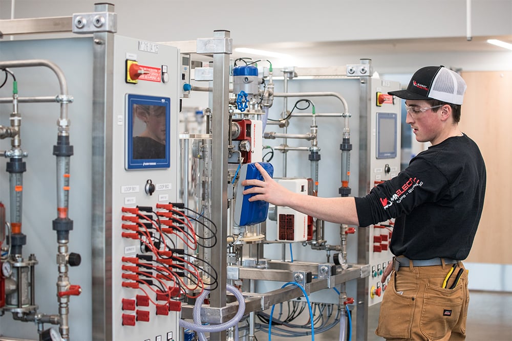 Student working with industrial equipment