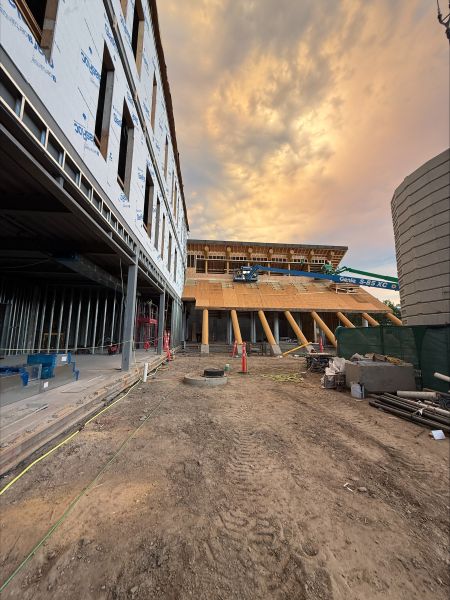 Exterior construction view of the Indigenous Centre showing the developing entrance and timber structure.