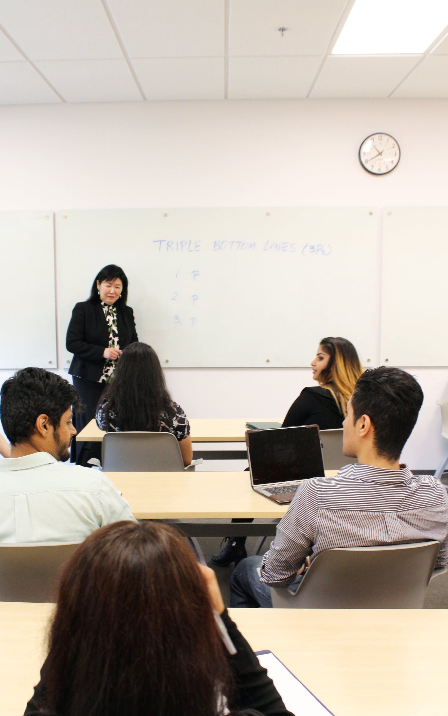 Teacher giving a lecture to students in classroom